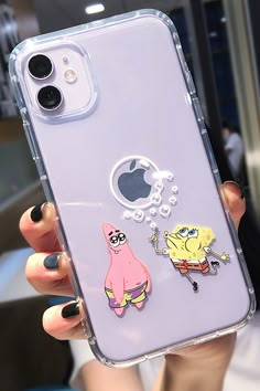 a person holding up a phone case with cartoon stickers on it's back