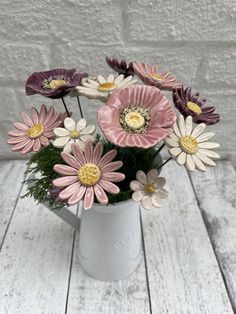 a vase filled with pink and white flowers