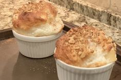 two muffins sitting on top of a baking pan next to a countertop