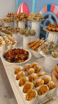 an assortment of food is displayed on a buffet table