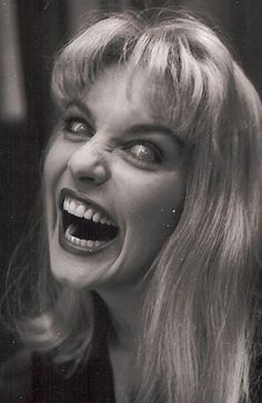 an old photo of a woman with her mouth open and teeth wide open, looking to the side