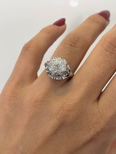 a woman's hand with a diamond ring on it