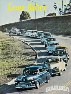 old cars are lined up on the side of the road