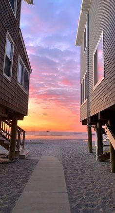 the sun is setting over some beach houses