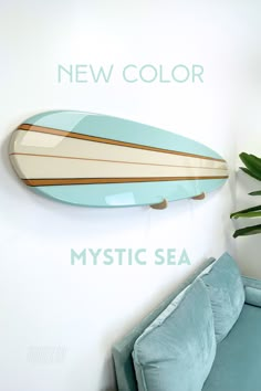 The perfect surfboard sign does exist. It's classic, it's coastal, it's beautiful. The board is made of wood, painted your choice of main color (the board pictured is indigo cloth) with a beige center and accented by stained stripes and black pinstripes to make it pop. Coated with clear epoxy, just like a real surfboard. If no text personalization is added the board will be finished with a pinstripe stringer down the middle rather than text. PLEASE NOTE: These boards are purely decorative and no Surf Board Floating Shelf, Surfboard Towel Rack, Wood Shark Wall Art, Decorative Surfboard Wall Art, Surf Board Decoration Wall Decor, Surfboard Home Decor, Wood Surfboard Decor, Blue Surf Aesthetic, Surfboard On Wall