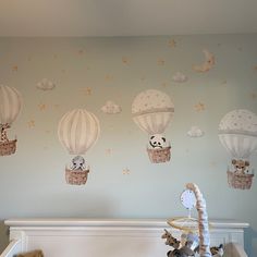 a baby's room with stuffed animals and hot air balloons