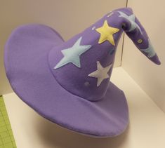 Trixie inspired magic hat.  It has an inner support so it can be posed like the show. This is one of many MLP character items that I make but if you want a character not listed here feel free to send me a message of which you would like and I'll see if I can get the proper colors of fabric and thread. Mlp Accessories, Mlp Trixie, Magic Hat, Mlp Characters, A Character, Floppy Hat, Travel Pillow, Etsy Listing, Caps Hats