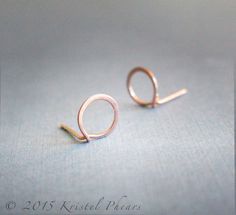 "Simple small circle ear studs, in solid 14k gold - recycled wire is hand-formed and hammered (flat hammered) to form these. Earrings come with very small solid 14k butterfly backs - note that the backs ONLY come in 14k yellow - if you want the backs in rose or white, it adds $10-20, contact me for a custom listing! They are about 8-9mm in diameter - photos 2-4 are of the sterling version of these, and I've included a penny for size reference in the last photo. I stamp these 14k (VERY tiny stamp Original Jewelry Design, Circle Stud Earrings, Rose Green, Team Board, Circle Earrings Studs, Solid Gold Earrings, Small Circle, Circle Studs, Argentium Silver