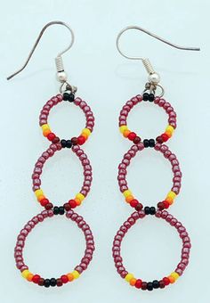 two pairs of red, yellow and black beaded earrings with silver hooks on white background