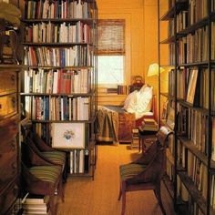 a room filled with lots of books and furniture