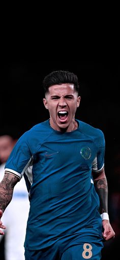 a soccer player with his mouth open and tongue out