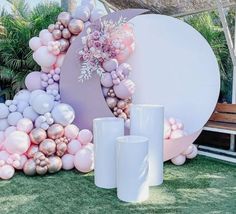 balloons and vases are arranged on the grass