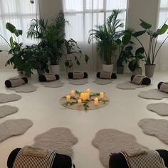 a table with candles and potted plants on it