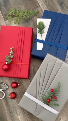 three different types of wrapping paper on a wooden floor with scissors and ornaments around them