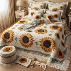 a bed with sunflowers on it in a room next to a table and lamp