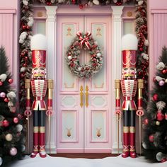 a pink door decorated for christmas with nutcrackers, wreath and garland on it