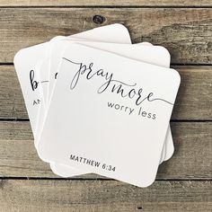 three white coasters with the words, pray those worry less written on them in cursive font