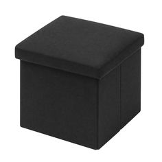 a black square ottoman sitting on top of a white floor