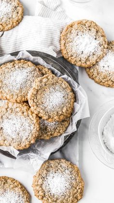 some cookies are on a plate with powdered sugar