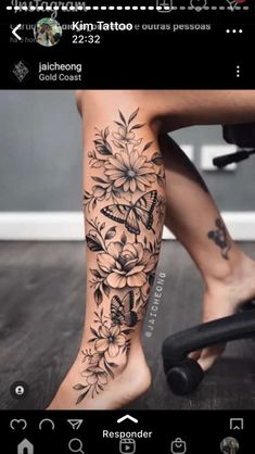 a woman's leg with flowers and butterflies tattooed on the bottom of her legs