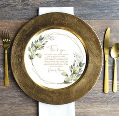 a place setting with goldware and white napkins