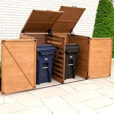 an open wooden storage box with two trash cans and one blue bin in the middle