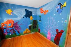 this room has an underwater theme painted on the wall and floor, along with wooden floors