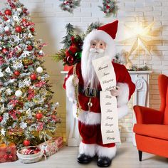 a santa clause holding a sheet of paper in front of a christmas tree and fireplace