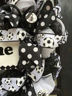 a black and white soccer wreath with the word gone on it, hanging from a door