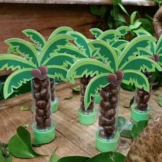 there are palm trees made out of chocolates on the table in front of some plants