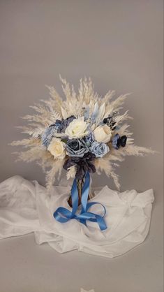 a bridal bouquet with white and blue flowers