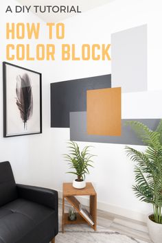 a black chair sitting in front of a white wall with an orange and gray color block on it