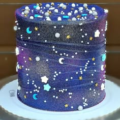 a blue cake with stars and moon designs on it