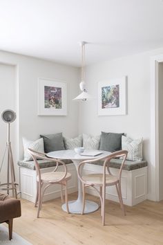 a living room with white walls and wooden floors