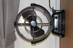 a fan mounted to the side of a wall