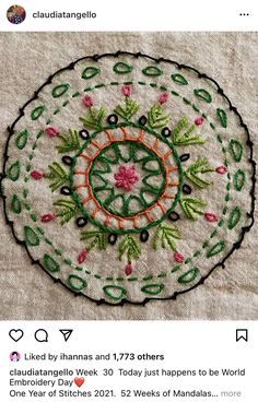 an embroidered doily with flowers and leaves on it