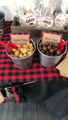 three buckets filled with food sitting on top of a red and black checkered table cloth