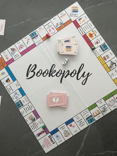 a board game with the words bookoply written on it and several pieces of paper