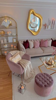 a living room filled with lots of furniture next to a wall mounted gold framed mirror