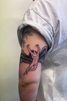 a man with an angel tattoo on his arm