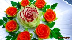 a white plate topped with orange flowers and green leaves