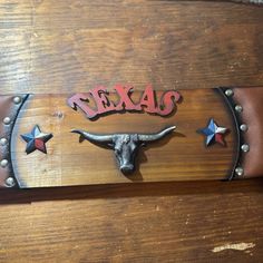 a longhorn steer with the word texas painted on it's face and stars