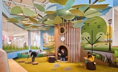 the children's playroom is decorated with colorful murals and playful trees, while people sit on beanbag chairs