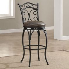 an iron bar stool with brown leather upholstered seat and back rests against a beige carpeted floor