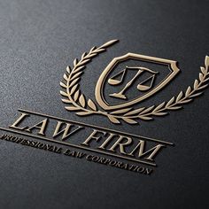 the law firm logo is shown on a black surface with gold foil and laurels