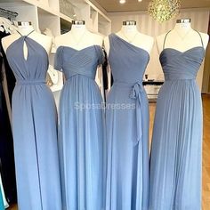 three bridesmaid dresses on mannequins in a store