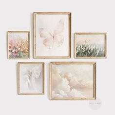 four framed paintings hang on the wall next to each other, one with a white bow