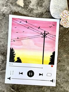 an image of a music player with birds flying in the sky and trees behind it