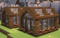 a small house made out of wood and stone in the middle of a minecraft village