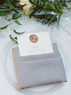 a place setting with napkins and flowers